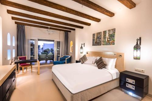 a bedroom with a bed and a living room at Hilton Marsa Alam Nubian Resort in Abu Dabab