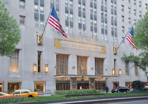 a building with two american flags in front of it at Waldorf Astoria New York in New York