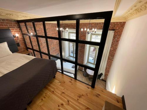 a room with a bed and a large window at Pod Błękitnymi Podkowami in Wrocław