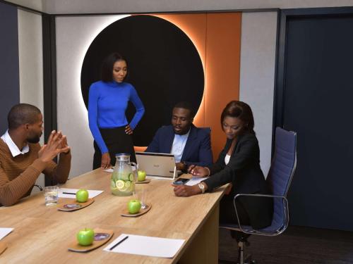a group of people sitting around a table at Novotel Lubumbashi in Lubumbashi