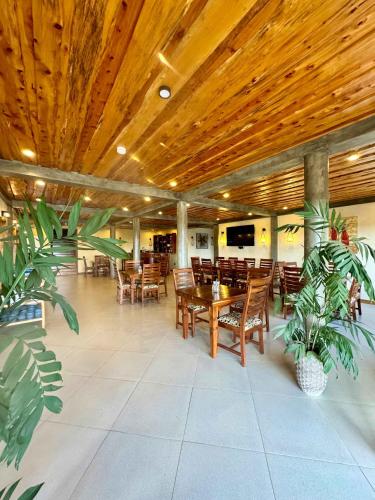 a restaurant with wooden ceilings and wooden tables and chairs at Moshono Hillside in Arusha