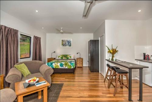 a living room with a bed and a desk at Eumundi Cottages - Cottage 1 in Eumundi