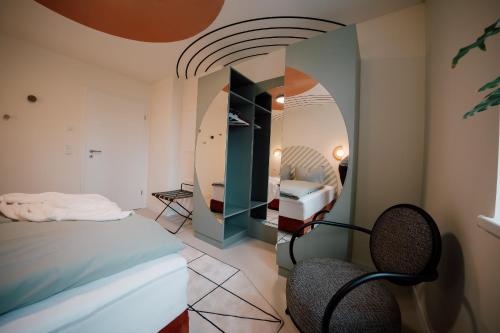 a bedroom with a bed and a mirror at Villa Haag - Design-Apartment in Fulda