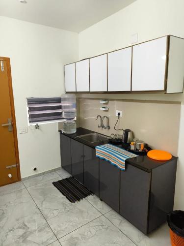 a kitchen with a sink and a counter top at Shams al Imarat in Palakkad
