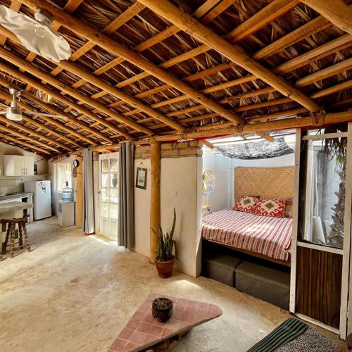 a living room with a bed and a table at La Sardina in Todos Santos