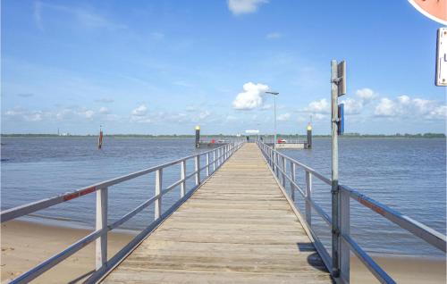 a wooden pier stretches out into the water at Nice Home In Drochtersen in Drochtersen