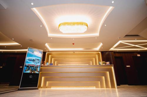 a hotel lobby with a cash register and a ceiling at Royal Raj Hotel in Rājshāhi
