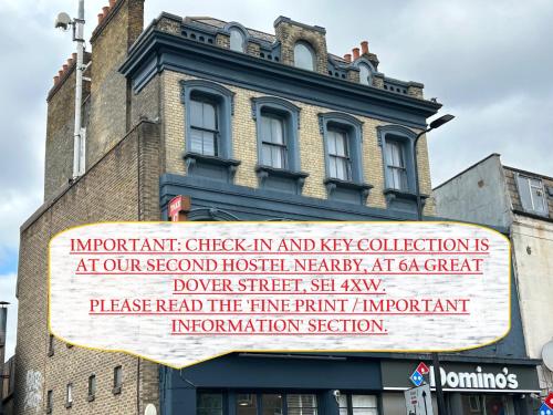 a sign on the side of a building at Cricketers Hostel in London