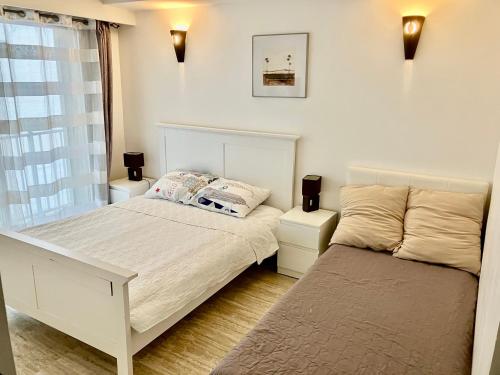 une chambre avec deux lits et une fenêtre dans l'établissement Grand 2 pieces- Marche Forville, à Cannes