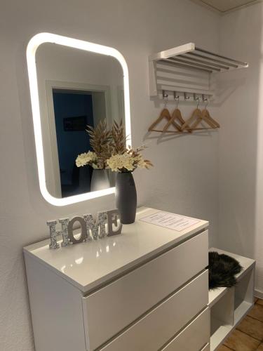 a white dresser with a mirror on top of it at Best in Town in Walldorf