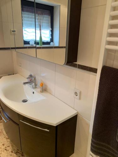 a bathroom with a sink and a mirror at Best in Town in Walldorf