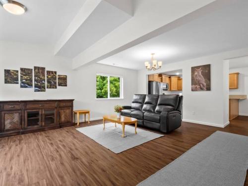 a living room with a couch and a table at The Sequoia a New 4bd with Soak Tub and Sauna Olympia in Olympia