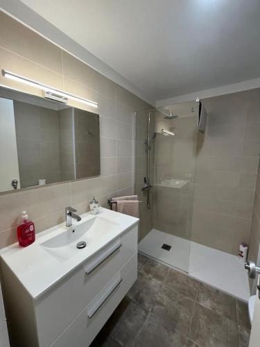 a white bathroom with a sink and a shower at Playa Jardín Bus terminal Pool in Puerto de la Cruz