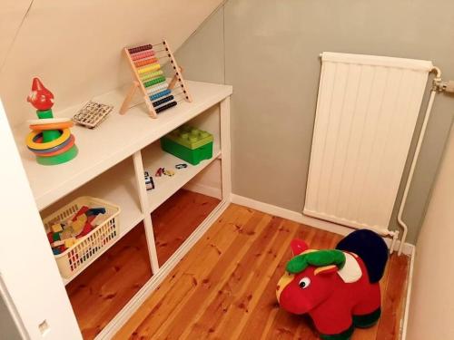 a childs room with a white shelf and a wooden floor at Stort hus, underbar utsikt & 3 min till Isaberg! in Hestra