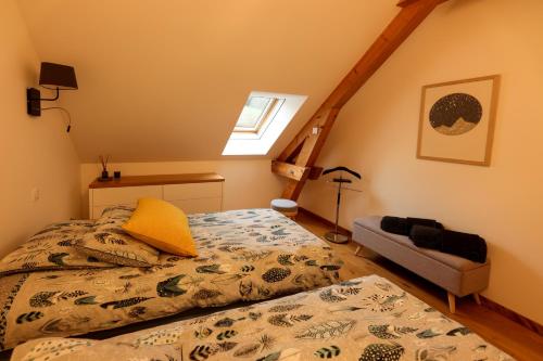 a bedroom with a bed with a yellow pillow at Maison d'hôtes & SPA La Scierie in Salins-les-Bains