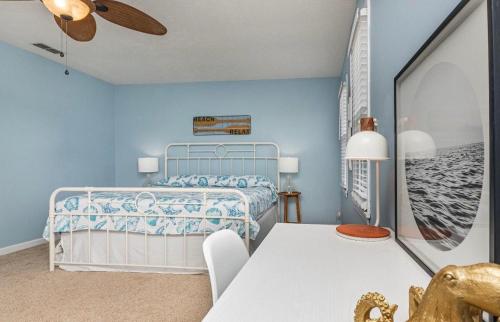 a blue bedroom with a bed and a table at Seaside Haven in Myrtle Beach