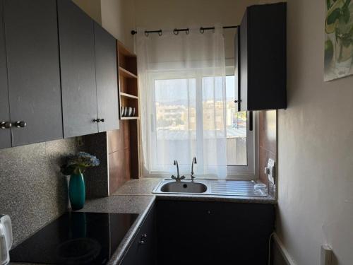 a small kitchen with a sink and a window at Poseidon Breeze in Limassol