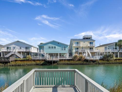 a bridge over a body of water with houses at Lazy Days in Cherry Grove! in Myrtle Beach