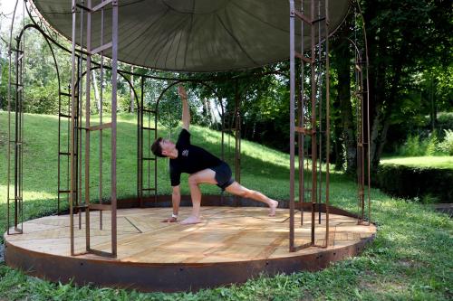 a woman standing on a dance floor in a structure at Maison d'hôtes & SPA La Scierie in Salins-les-Bains