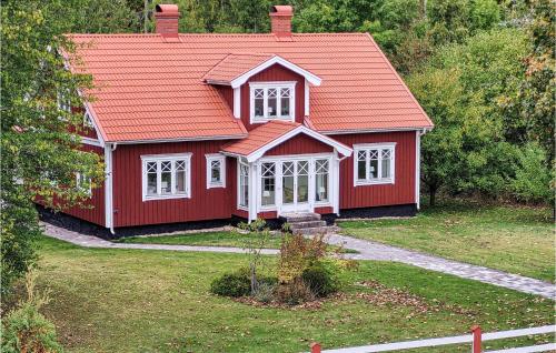 a red house with an orange roof at Gorgeous Home In Älmeboda With Sauna in Älmeboda
