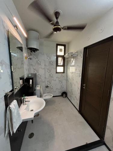 a bathroom with a sink and a toilet at Colonel's Abbey First Floor in Jaipur