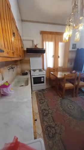 a kitchen being remodeled with a stove and a table at ΑΡΜΟΝΙΑ MountHome awesome stay in Arachova