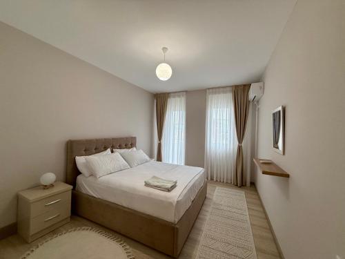 a bedroom with a large bed and a window at Dona's Home in Shkodër