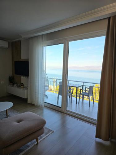 a living room with a large sliding glass door with a view at Shiroka's Special Guest 1 in Široka