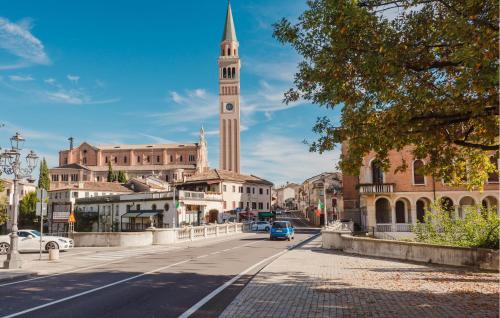 a city street with a clock tower in the distance at Gorgeous Home In Pieve Di Soligo in Pieve di Soligo