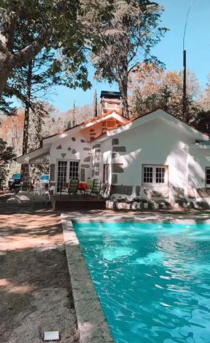 a house with a swimming pool in front of it at Quinta da Hortigueira - Country House in Trancoso