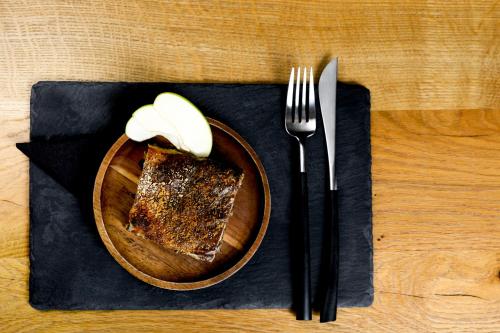 a plate of food with a piece of cake and a fork at Maison d'hôtes & SPA La Scierie in Salins-les-Bains