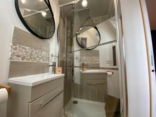 a bathroom with a shower and a sink and a mirror at Armonid au coeur de Cabourg in Cabourg