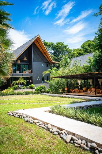a house with a stone walkway in front of it at Namu Garden Hotel & Spa - Adults Only in Puerto Viejo