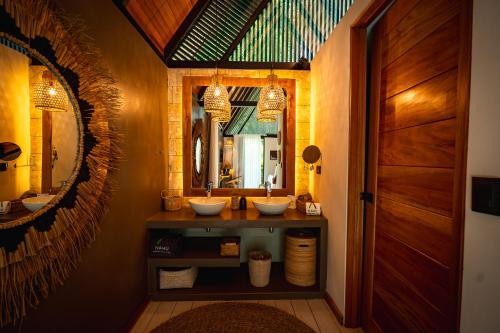a bathroom with two sinks and a mirror at Namu Garden Hotel & Spa - Adults Only in Puerto Viejo