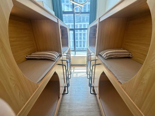 two empty shelves in a room with a window at 安家青年寓舍深圳北站店Anjia Youth Hostel Shenzhen Railway North Branch in Lung Wa