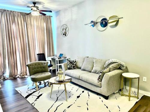 a living room with a couch and a table at Beautiful Uptown Adventure Apartment in Charlotte