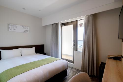 Postel nebo postele na pokoji v ubytování Hotel Enoe Hakodate