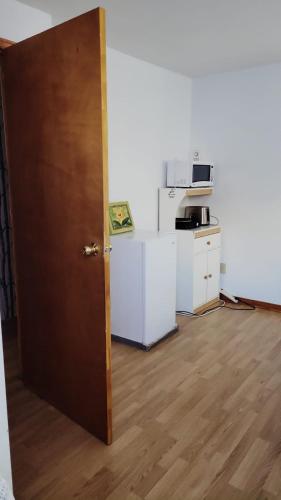 an open door in a room with a kitchen at CosyRoom in Brossard