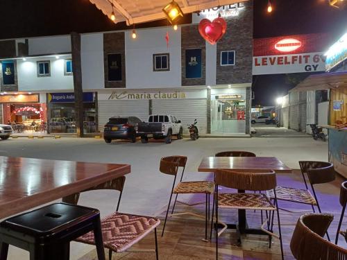 a restaurant with tables and chairs and a parking lot at Hotel Mall plaza in Santa Marta