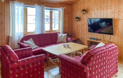 un soggiorno con 2 divani rossi e un tavolo di 3 Bedroom Nice Home In Bjorli a Bjorli
