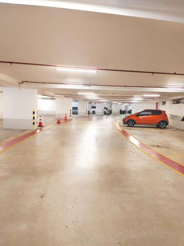 an empty parking garage with a car parked in it at Sky Suites KLCC by KD Luxury Suites in Kuala Lumpur