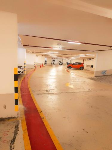 an empty parking garage with a car parked in it at Sky Suites KLCC by KD Luxury Suites in Kuala Lumpur