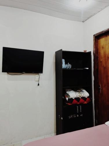 a black cabinet in a room with a wall at Mi Hábitat in Asuncion
