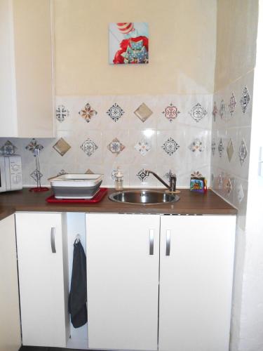 une cuisine avec des armoires blanches et un évier dans l'établissement Entre Saint-Tropez et les gorges du Verdon., à Lorgues