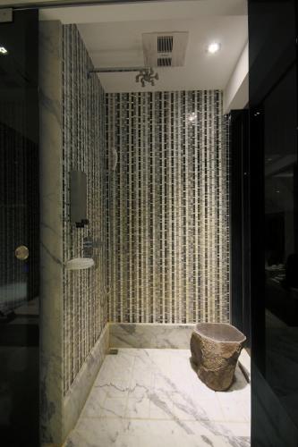 a bathroom with a shower with a chair in it at Region Motel in Lugang