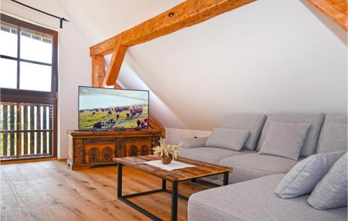 a living room with a couch and a tv at 2 Bedroom Stunning Apartment In Mozirje in Mozirje