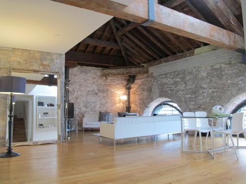 a living room with a white couch and a table at 45 Brewhouse - Royal William Yard in Plymouth