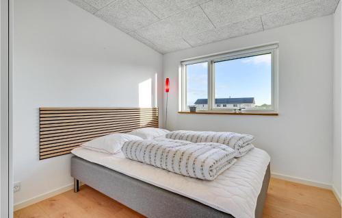 a white bedroom with a bed with a window at Lovely Home In Spøttrup With Wifi in Spottrup