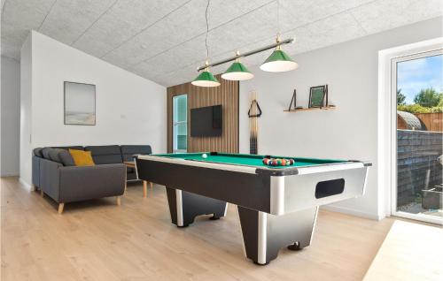 a living room with a pool table and a couch at Gorgeous Home In Ebeltoft With Sauna in Ebeltoft