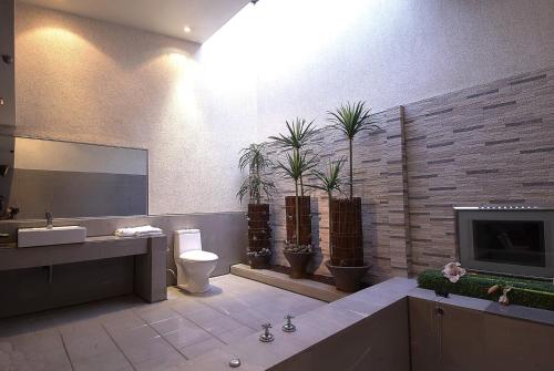 a bathroom with a sink and a toilet and a tv at Region Motel in Lugang